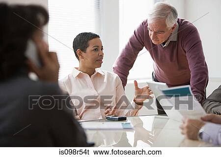 Stock Photograph - Colleagues in meeting. Fotosearch
