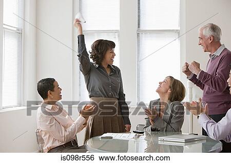 Stock Photograph - Happy colleagues in meeting. Fotosearch