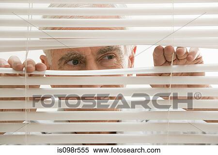 Man looking through blinds View Large Photo Image Stock Photography - Man looking through blinds. Fotosearch