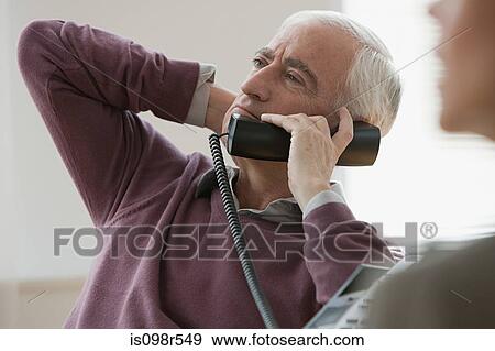 Man on telephone View Large Photo Image Stock Photo - Man on telephone. Fotosearch