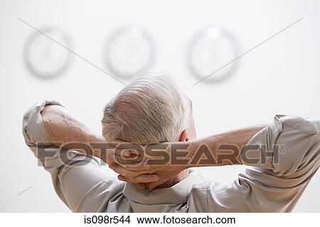 Man with hands behind head View Large Photo Image Picture - Man with hands behind head. Fotosearch