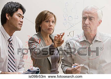 People looking at diagram on glass wall View Large Photo Image Picture - People looking at diagram on glass wall. Fotosearch