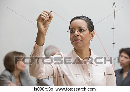 Stock Photography - Woman drawing graph on glass. Fotosearch
