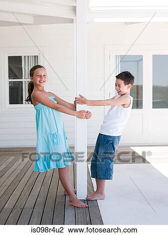 Brother and sister at beach house View Large Photo Image Stock Image - Brother and sister at beach house. Fotosearch