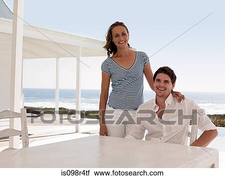 Couple at beach house View Large Photo Image Stock Image - Couple at beach house. Fotosearch