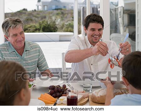 Family meal outdoors View Large Photo Image Stock Image - Family meal outdoors. Fotosearch
