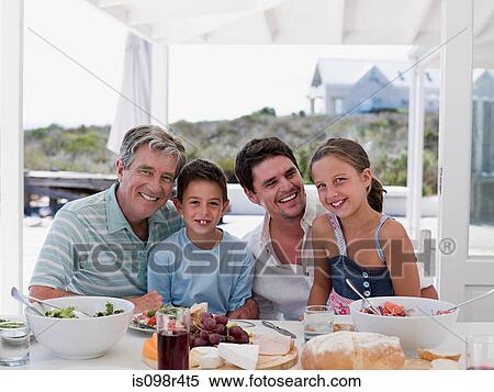 Stock Photography - Family meal outdoors. Fotosearch