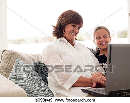 Girl and grandmother with laptop View Large Photo Image Stock Photo - Girl and grandmother with laptop. Fotosearch