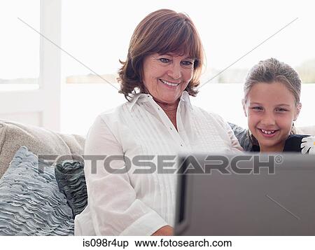 Girl and grandmother with laptop View Large Photo Image Stock Photography - Girl and grandmother with laptop. Fotosearch