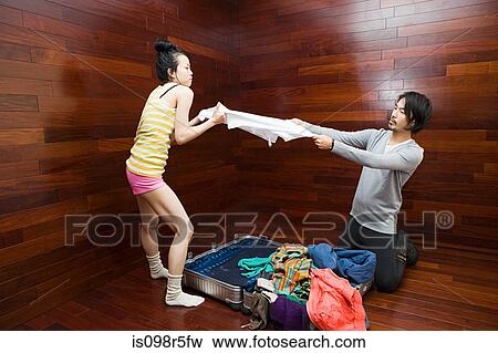 Couple fighting over clothes View Large Photo Image Stock Photo - Couple fighting over clothes. Fotosearch