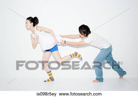 Couple fighting over pillow View Large Photo Image Stock Photo - Couple fighting over pillow. Fotosearch