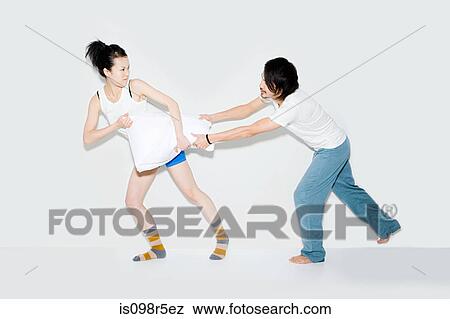 Couple fighting over pillow View Large Photo Image Stock Photo - Couple fighting over pillow. Fotosearch