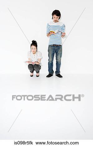 Couple reading magazines View Large Photo Image Stock Image - Couple reading magazines. Fotosearch