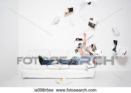 Man throwing pages of a magazine View Large Photo Image Stock Image - Man throwing pages of a magazine. Fotosearch