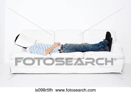 Man with magazine over face View Large Photo Image Stock Image - Man with magazine over face. Fotosearch
