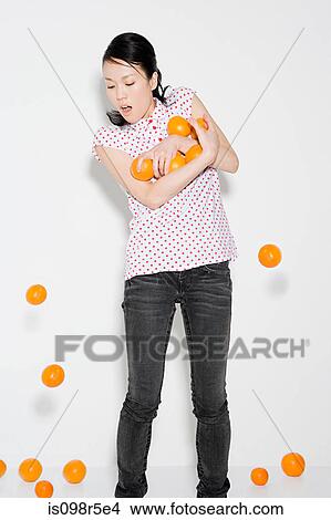 Picture - Woman dropping oranges. Fotosearch