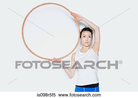 Stock Photography - Woman holding hoop. Fotosearch