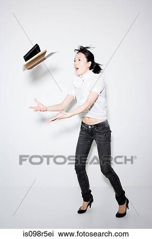 Woman throwing books View Large Photo Image Stock Image - Woman throwing books. Fotosearch