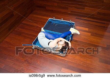 Young woman in a suitcase View Large Photo Image Stock Photo - Young woman in a suitcase. Fotosearch