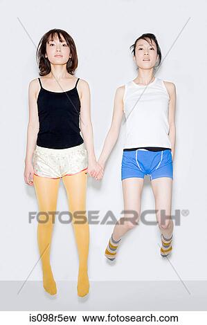 Young women jumping View Large Photo Image Stock Photo - Young women jumping. Fotosearch