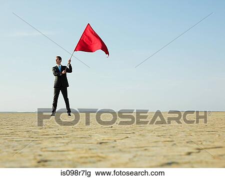Businessman holding a red flag View Large Photo Image Stock Image - Businessman holding a red flag. Fotosearch