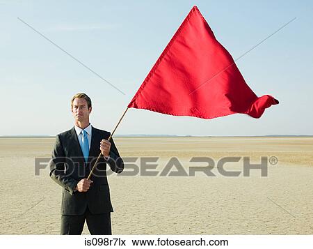 Businessman holding a red flag View Large Photo Image Stock Photo - Businessman holding a red flag. Fotosearch