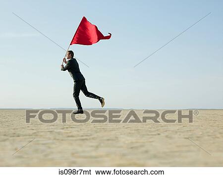 Stock Photograph - Businessman holding a red flag. Fotosearch