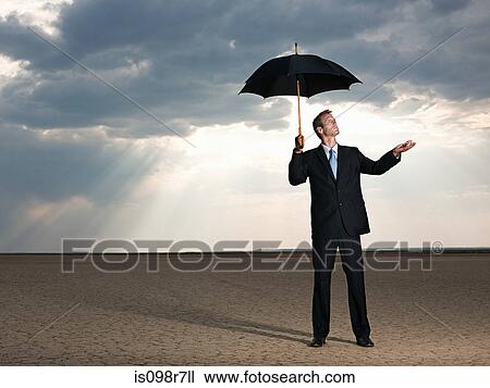 Businessman in the desert with an umbrella View Large Photo Image Stock Image - Businessman in the desert with an umbrella. Fotosearch