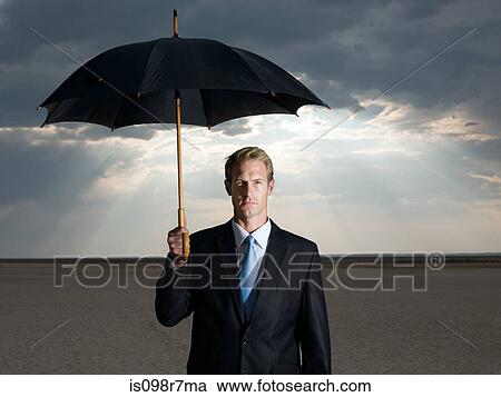 Businessman in the desert with an umbrella View Large Photo Image Stock Image - Businessman in the desert with an umbrella. Fotosearch