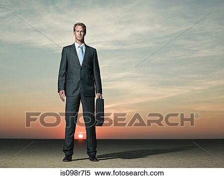 Businessman standing in the desert View Large Photo Image Stock Photography - Businessman standing in the desert. Fotosearch