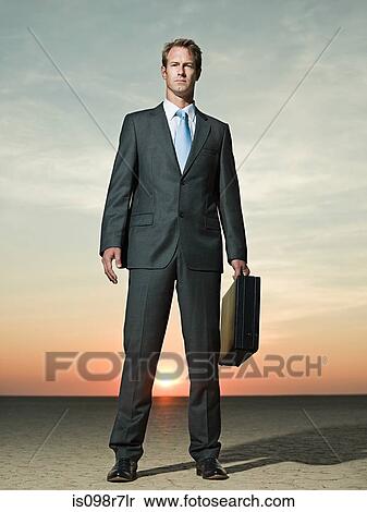 Businessman standing in the desert View Large Photo Image Stock Photography - Businessman standing in the desert. Fotosearch