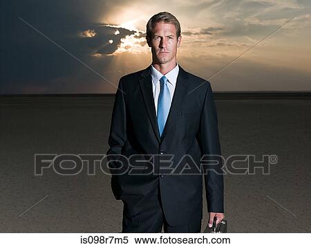 Businessman standing in the desert View Large Photo Image Stock Photography - Businessman standing in the desert. Fotosearch