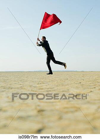 Businessman waving a red flag View Large Photo Image Picture - Businessman waving a red flag. Fotosearch