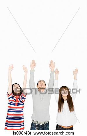 Stock Photograph - People with arms raised. Fotosearch