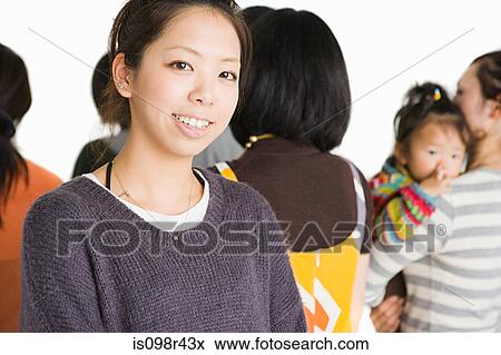 Young woman in group of people View Large Photo Image Stock Photo - Young woman in group of people. Fotosearch