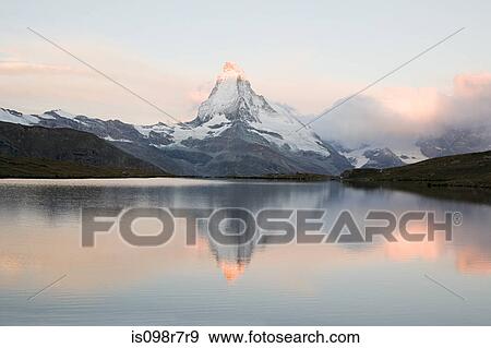 Stock Photo - Matterhorn reflected in lake at sunset. Fotosearch