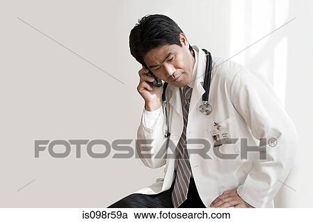Doctor on cellphone View Large Photo Image Stock Image - Doctor on cellphone. Fotosearch