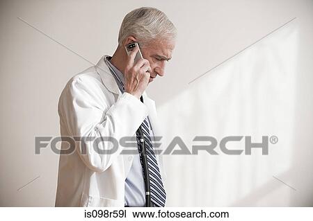 Stock Image - Doctor on cellphone. Fotosearch