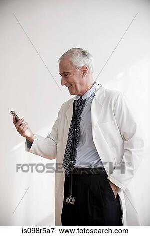 Doctor with cellphone View Large Photo Image Stock Photo - Doctor with cellphone. Fotosearch