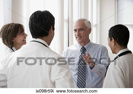 Stock Image - Doctors having discussion. Fotosearch