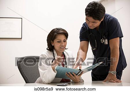 Doctors looking at file View Large Photo Image Stock Photo - Doctors looking at file. Fotosearch