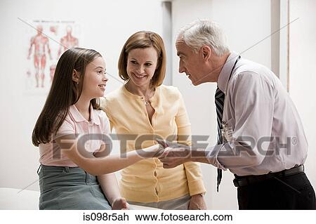 Girl and mother at doctors office View Large Photo Image Stock Image - Girl and mother at doctors office. Fotosearch