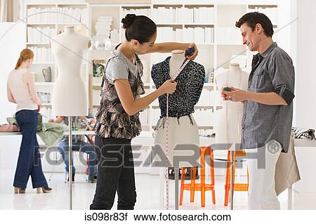 Stock Image - Fashion designers at work. Fotosearch