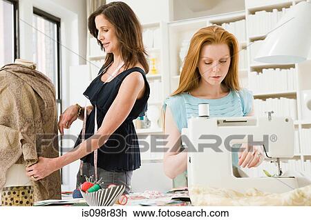 Stock Image - Fashion designers at work. Fotosearch