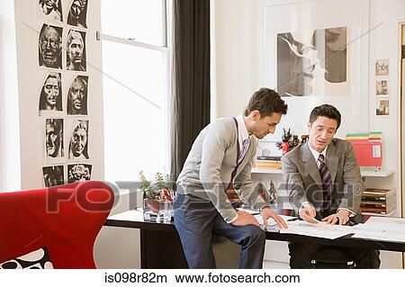 Picture - Fashion designers having discussion. Fotosearch