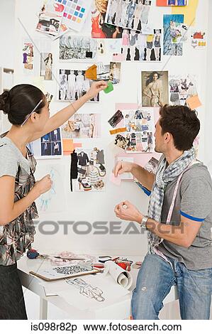 Fashion designers looking at sketches View Large Photo Image Stock Photography - Fashion designers looking at sketches. Fotosearch
