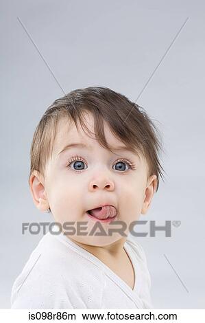 Baby sticking out tongue View Large Photo Image Picture - Baby sticking out tongue. Fotosearch