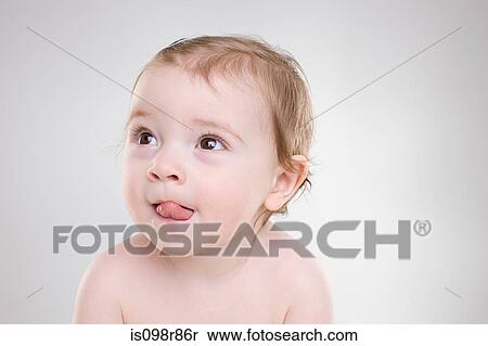 Stock Photography - Baby sticking out tongue. Fotosearch