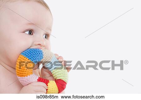 Picture - Baby with a teething ring. Fotosearch