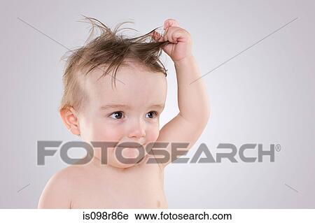 Baby with tousled hair View Large Photo Image Stock Image - Baby with tousled hair. Fotosearch